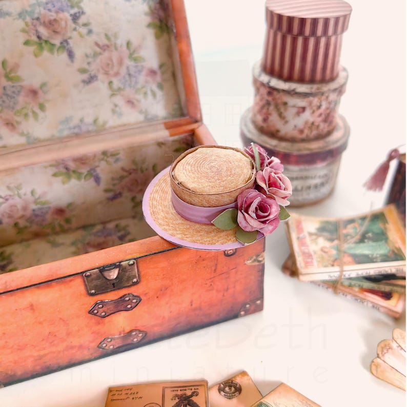 1:12 scale Victorian dollhouse miniature ephemera and accessory set. This printable digital kit features a vintage steamer trunk, floral photo album, personal journal, and over 200 nostalgic paper treasures. Designed by LittleBethMiniature for vintage dollhouse collectors.