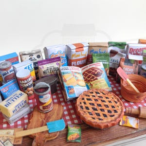 It is a Dollhouse Miniature Baking/ Cooking set that includes various items such as 45 different pieces Miniature Food, Mini Grocery boxes, Cooking Ingredients, Kitchenware, Recipes and Cookbook. Download PDF printables and get started making.