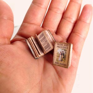 1:12 scale Victorian dollhouse miniature ephemera and accessory set. This printable digital kit features a vintage steamer trunk, floral photo album, personal journal, and over 200 nostalgic paper treasures. Designed by LittleBethMiniature for vintage dollhouse collectors.
