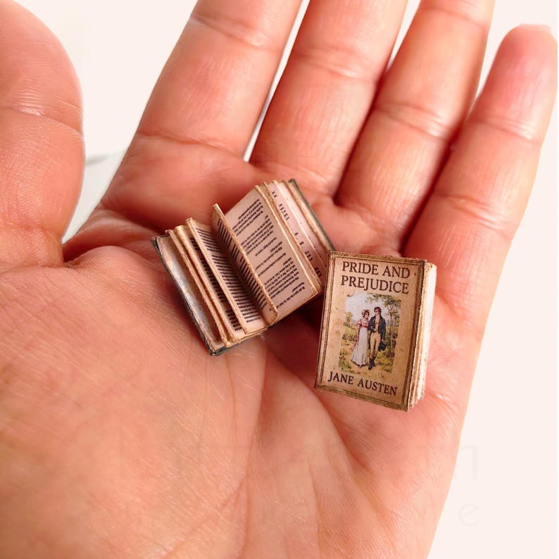 1:12 scale Victorian dollhouse miniature ephemera and accessory set. This printable digital kit features a vintage steamer trunk, floral photo album, personal journal, and over 200 nostalgic paper treasures. Designed by LittleBethMiniature for vintage dollhouse collectors.