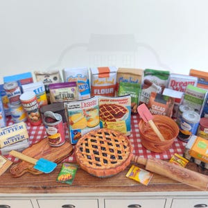 It is a Dollhouse Miniature Baking/ Cooking set that includes various items such as 45 different pieces Miniature Food, Mini Grocery boxes, Cooking Ingredients, Kitchenware, Recipes and Cookbook. Download PDF printables and get started making.