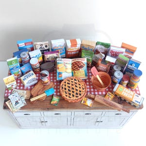 It is a Dollhouse Miniature Baking/ Cooking set that includes various items such as 45 different pieces Miniature Food, Mini Grocery boxes, Cooking Ingredients, Kitchenware, Recipes and Cookbook. Download PDF printables and get started making.