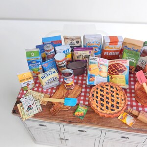It is a Dollhouse Miniature Baking/ Cooking set that includes various items such as 45 different pieces Miniature Food, Mini Grocery boxes, Cooking Ingredients, Kitchenware, Recipes and Cookbook. Download PDF printables and get started making.