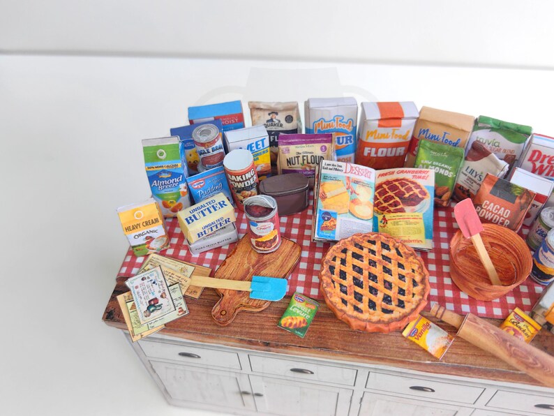 It is a Dollhouse Miniature Baking/ Cooking set that includes various items such as 45 different pieces Miniature Food, Mini Grocery boxes, Cooking Ingredients, Kitchenware, Recipes and Cookbook. Download PDF printables and get started making.