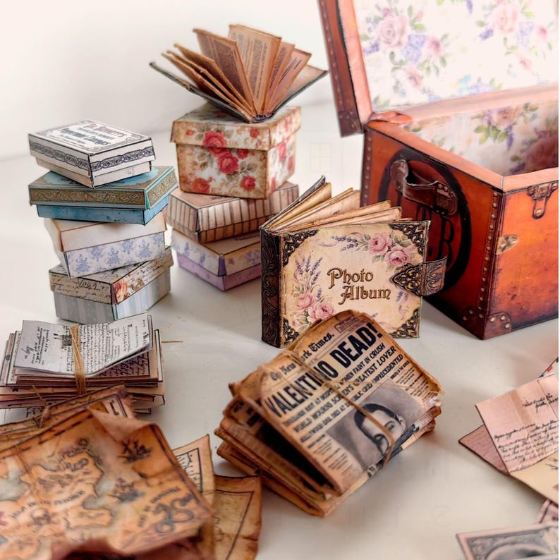 1:12 scale Victorian dollhouse miniature ephemera and accessory set. This printable digital kit features a vintage steamer trunk, floral photo album, personal journal, and over 200 nostalgic paper treasures. Designed by LittleBethMiniature for vintage dollhouse collectors.