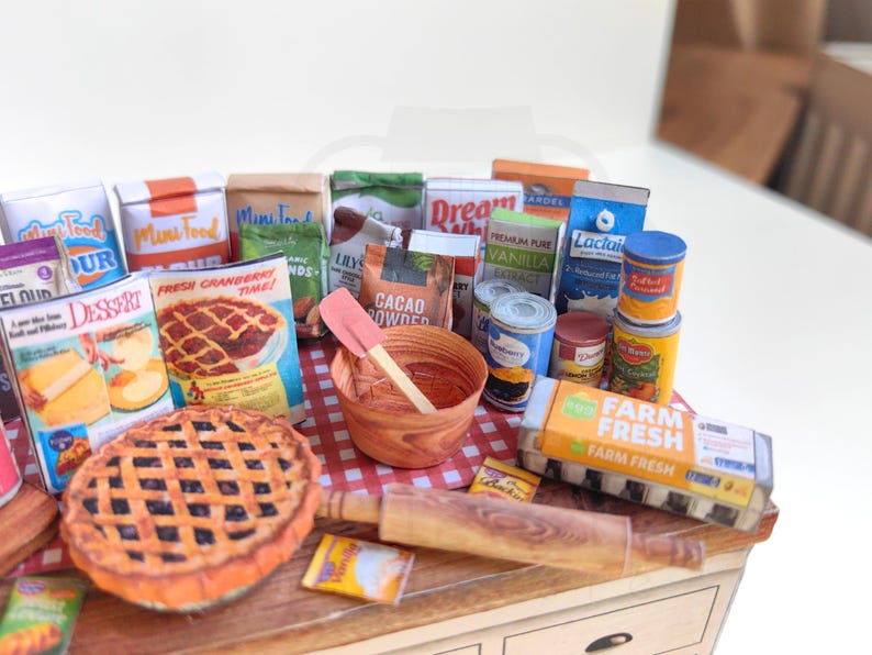 It is a Dollhouse Miniature Baking/ Cooking set that includes various items such as 45 different pieces Miniature Food, Mini Grocery boxes, Cooking Ingredients, Kitchenware, Recipes and Cookbook. Download PDF printables and get started making.