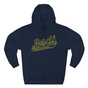 May include: Navy blue hooded sweatshirt with a yellow "Lodi" script design. The text "Mokelumne Station" is below the script. The sweatshirt has a front pocket and a hood with a drawstring.