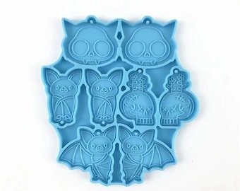 Puede incluir: Molde de silicona azul con ocho formas diferentes de murciélagos y calaveras. El molde está diseñado para hacer manualidades de resina.