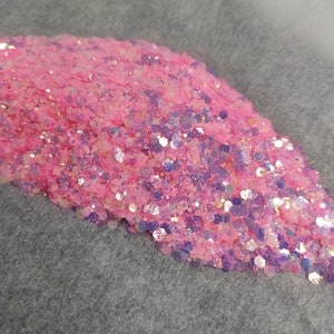 May include: A pile of pink and iridescent glitter with a holographic finish.