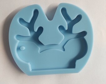 May include: A light blue silicone mold shaped like a reindeer with antlers. The mold is designed for making resin crafts.