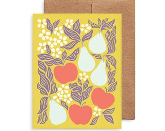 May include: Greeting card with a yellow background featuring a pattern of red apples, white pears, and white flowers with purple leaves. The card is paired with a brown envelope.