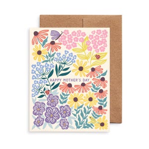 May include: A floral "Happy Mother's Day" greeting card with a colorful design. The card features illustrations of various flowers, a butterfly, and a ladybug. The card is paired with a brown envelope.