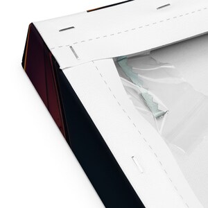 May include: Close-up of a wrapped canvas print. The canvas is stretched over a wooden frame and stapled in place. The edges of the canvas are white, and the artwork is visible on the side. The canvas is wrapped in plastic.