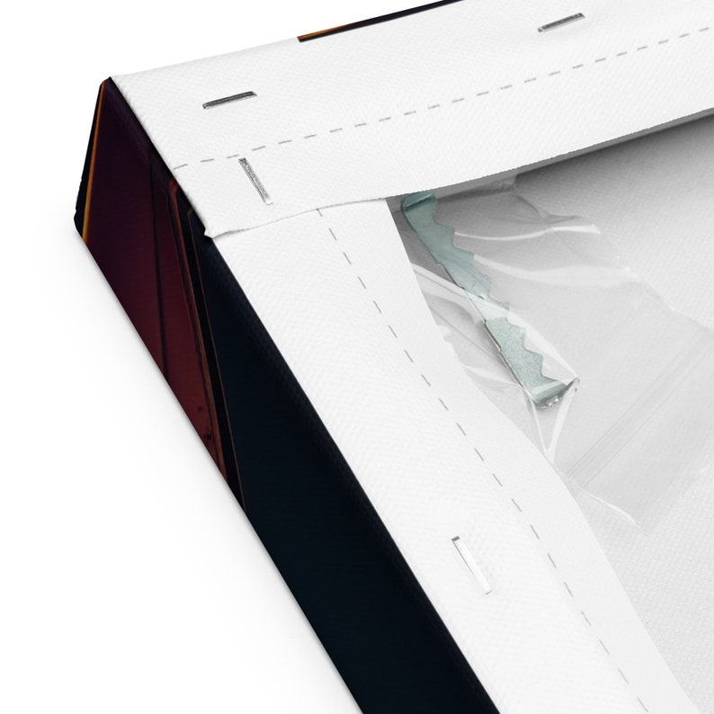 May include: Close-up of a wrapped canvas print. The canvas is stretched over a wooden frame and stapled in place. The edges of the canvas are white, and the artwork is visible on the side. The canvas is wrapped in plastic.