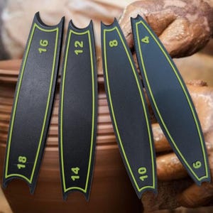 May include: Set of five black pottery tools with green markings. The tools are labelled with numbers 4, 6, 8, 12, and 16.
