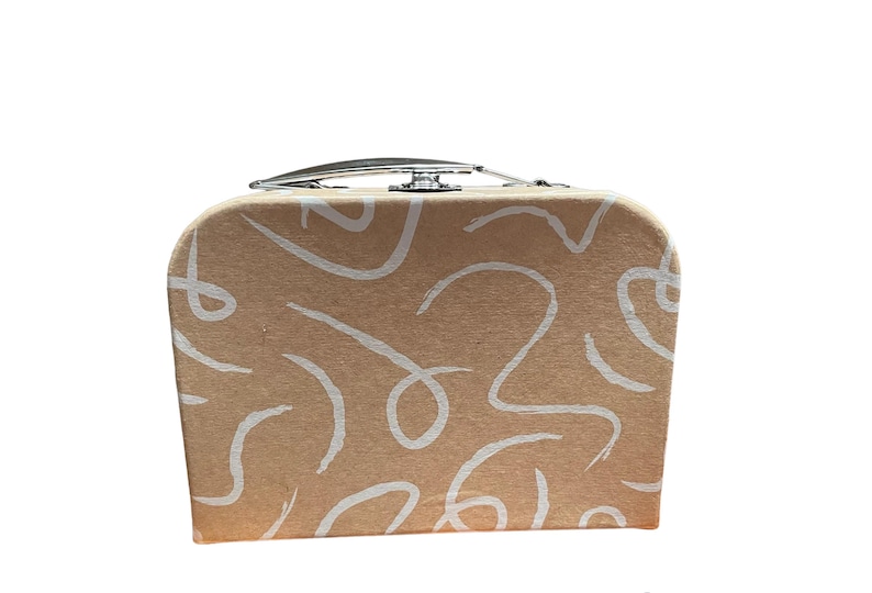May include: A small, tan-colored suitcase with a silver handle and clasp. The suitcase is decorated with white, abstract, swirling lines. The design is repeated across the front and sides of the case.