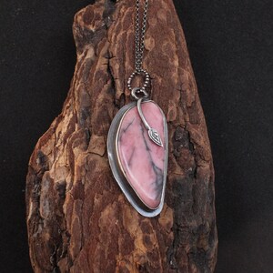 British Columbia Rhodonite Snuggled into a Bezel Setting with a leaf &quot;hug&quot; in a Fine Silver (99.9%) Pendant on 1mm Patina Curb Chain