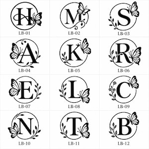 Op de afbeelding: Een raster van twaalf zwarte cirkelvormige monogrammen op een witte achtergrond, elk met een unieke hoofdletter van H tot B, versierd met vlinder- en bladmotieven. Elk ontwerp is gelabeld met een code van LB-01 tot LB-12 onder de cirkel.