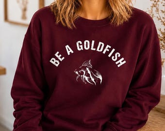 Sudadera unisex de cuello redondo "Be a Goldfish" - Mezcla Gildan cómoda para cualquier ocasión