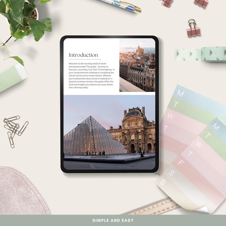 May include: A tablet displaying a travel guide with images of cityscapes and the Louvre Museum. The text reads "Introduction" and "SIMPLE AND EASY". The tablet is surrounded by stationery, including a pen, paper clips, and a weekly planner.