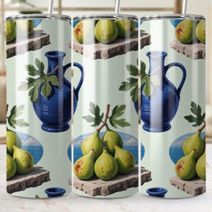 May include: A tumbler featuring a repeating pattern of a blue vase with a fig leaf, figs, and a blue plate. The figs are green with red spots. The background is a light green colour.