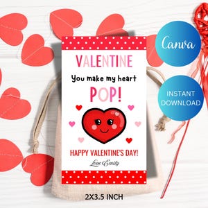 May include: Red and white Valentine's Day card with a red heart with a smiling face and the text "You make my heart POP!" and "Happy Valentine's Day! Love Emily". The card is 2x3.5 inches.