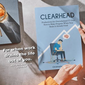 May include: A person holding a light blue book titled "CLEARHEAD" with the subtitle "Productivity for Overwhelmed IT Guys." The cover illustration depicts a tired person in a chair. The text "For when work drains the life out of you" is also visible.