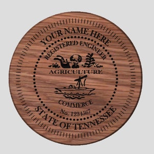 May include: A round wooden plaque with a black engraved seal. The seal features the text "YOUR NAME HERE REGISTERED ENGINEER AGRICULTURE COMMERCE STATE OF TENNESSEE" and a design of a ship, a tree, and a hand holding a plow. The seal also includes the text "No. 1234567".