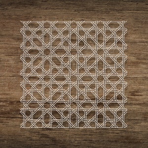May include: A white geometric pattern on a brown wood background. The pattern is made up of a series of interlocking squares and rectangles.