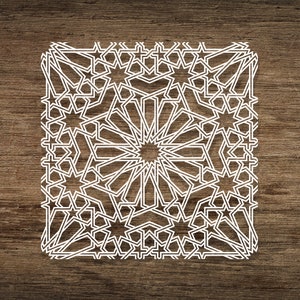 May include: White geometric pattern with a starburst design on a brown wood background.