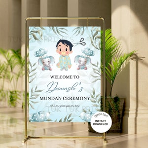 Puede incluir: Un cartel de bienvenida azul y verde para la ceremonia de mundan de un bebé. El cartel presenta a un bebé varón de dibujos animados con dos elefantes que sostienen globos. El texto en el cartel dice "Bienvenido a la ceremonia de mundan de Devansh. Nos alegra que estés aquí."