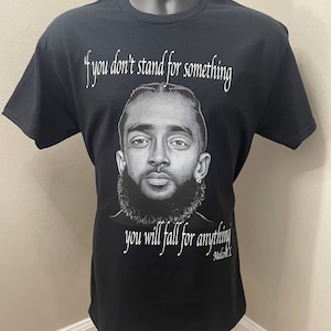 May include: Black t-shirt with a quote by Malcolm X: "If you don't stand for something you will fall for anything."