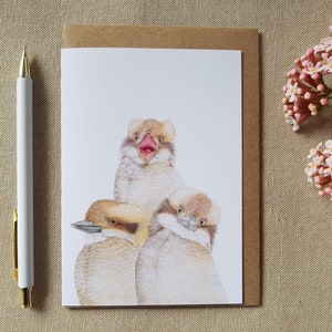 A gift card featuring a young Australian laughing kookaburra in three different cute poses. Blank inside for your own message.