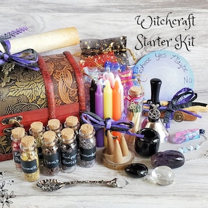 May include: A wooden chest filled with various witchcraft supplies, including herbs, candles, crystals, and a divination board. The chest is decorated with a floral pattern and has a keyhole. The text "Witchcraft Starter Kit" is written in cursive above the chest.
