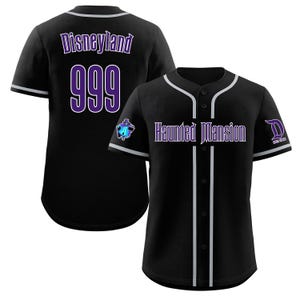 May include: Black baseball jersey with white piping and a purple "Haunted Mansion" text on the front. The back of the jersey has a purple "Disneyland" text and the number "999".