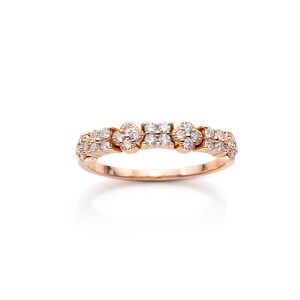 May include: A delicate rose gold band ring with a cluster of small diamonds set in a floral pattern.