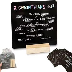 May include: A black chalkboard with the text "2 Corinthians 5:17" and related scripture. Includes a wooden eraser, a bag of small wooden blocks, and a stack of black cards with text.