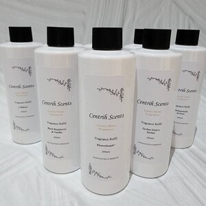 May include: A collection of white Centrih Scents fragrance refill bottles, each with a black cap. The labels display the brand name, fragrance type, and volume. Scents include Black Raspberry & Vanilla, Flowerbomb, and Lychee Guava Sorbet. Each bottle contains 200ml.
