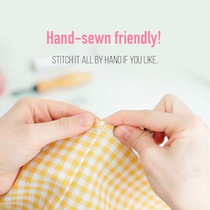 May include: A close-up of hands sewing yellow and white checkered fabric with a needle and thread. The text "Hand-sewn friendly!" and "STITCH IT ALL BY HAND IF YOU LIKE." are displayed in pink and black.