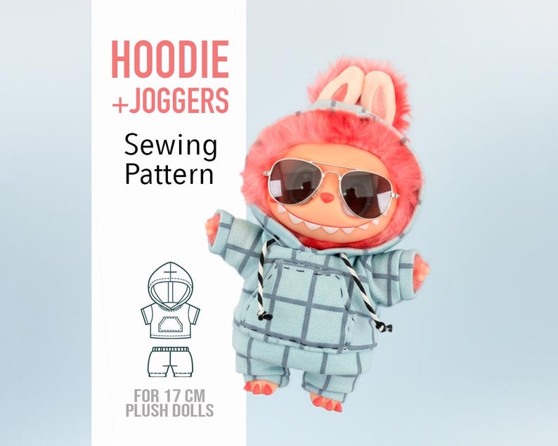 May include: A plush doll wearing a blue plaid hoodie and joggers, with sunglasses and a pink furry hood with bunny ears. The image includes text that reads "HOODIE + JOGGERS Sewing Pattern" and "FOR 17 CM PLUSH DOLLS".