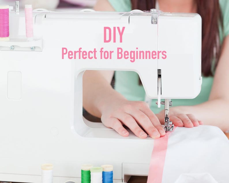 May include: A white sewing machine with pink thread and a pink ribbon. The text "DIY Perfect for Beginners" is displayed on the machine.