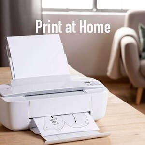 May include: A white printer with a sheet of paper in the tray. The paper has a design for a face mask with the words "Mouth Cut 1" printed on it. The text "Print at Home" is visible above the printer.