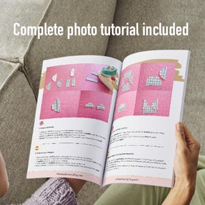 May include: An open book with pink pages displays a sewing tutorial with diagrams. The text "Complete photo tutorial included" is at the top. The book is held by a person sitting on a gray couch.