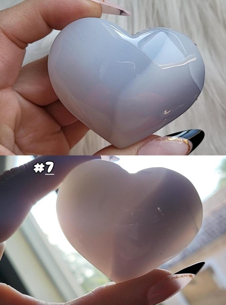 May include: A heart-shaped, polished stone in shades of pale blue and white. The stone is smooth and reflective, with subtle variations in color. The image includes the text "#7".