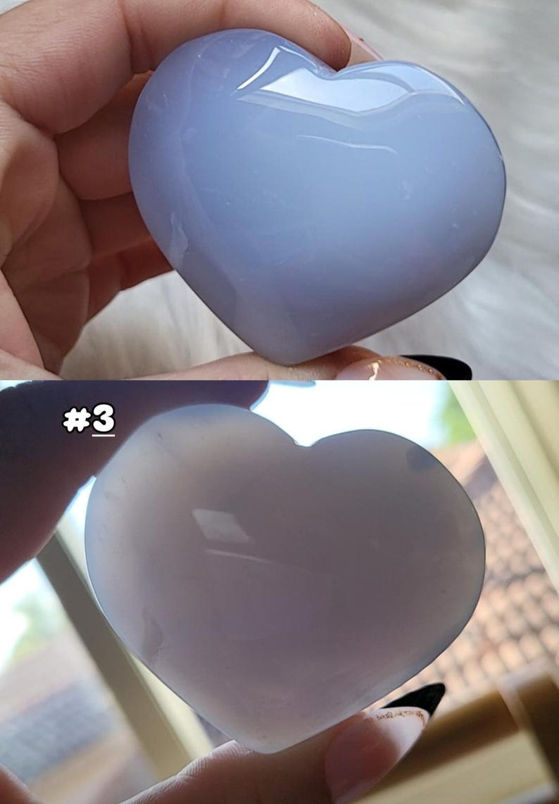 May include: Two heart-shaped stones in the image. The top stone is a light blue color, and the bottom stone is a lighter shade of blue. The stones are smooth and polished. The number "#3" is visible on the bottom image.