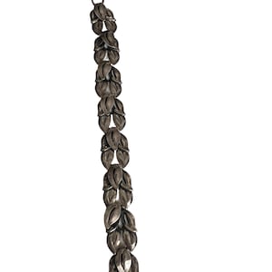 May include: A silver bracelet with a chain of linked leaf-shaped charms. The bracelet has a clasp closure.