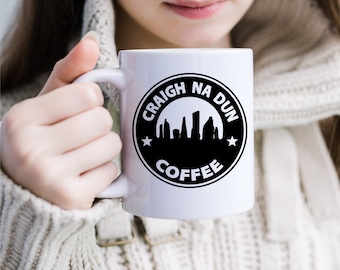 May include: White ceramic mug with a black circle design featuring the text "CRAIGH NA DUN COFFEE" and a silhouette of a city skyline.