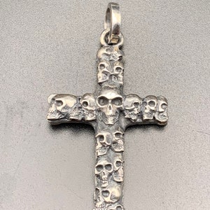 Amazing detail Handmade multi skulls cross pendant made by Brendan Davidson