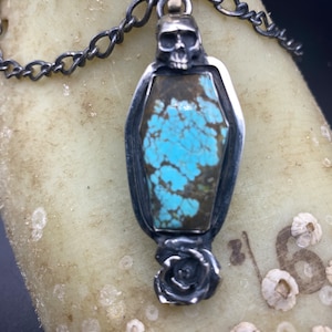 coffin shaped number 8 turquoise skull and flower pendant