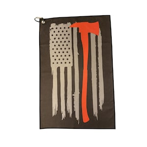 May include: A black golf towel with a distressed American flag design and a red firefighter axe.